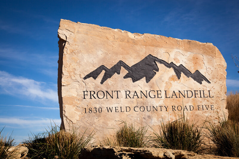 Stone slab with Front Range Landfill logo and addressed etched into it.