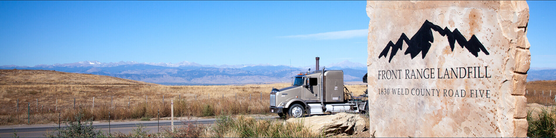 Photo of semi-truck driving down highway by Front Range Landfill.